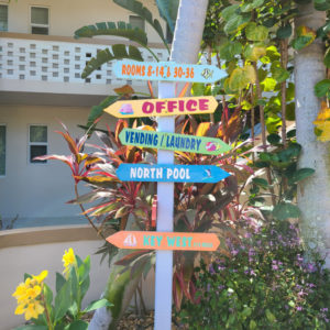 A colorful property sign showing the direction to our Office, North Pool, and Vending & Laundry