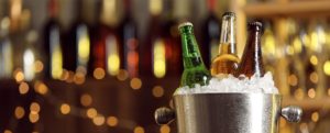 Bucket of iced beer with blurred background.