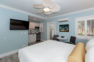 Studio Room with Queen Bed, Kitchenette, and dining table and two chairs.